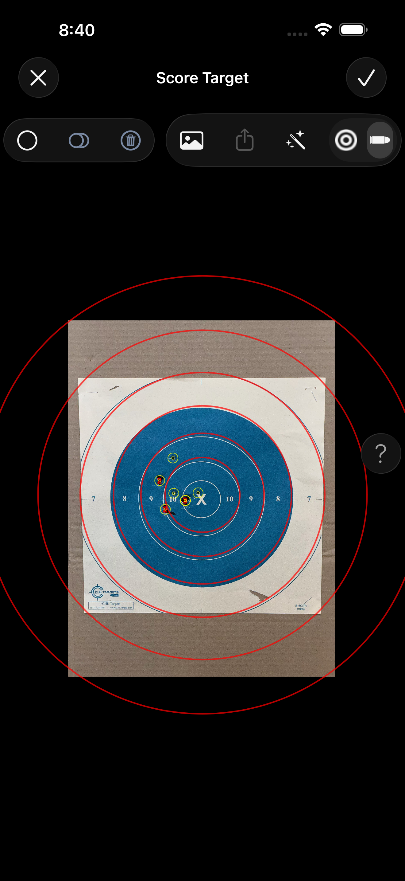 The Score Target screen showing a captured target image with red scoring rings overlaid and auto-detected shot markers placed on the target